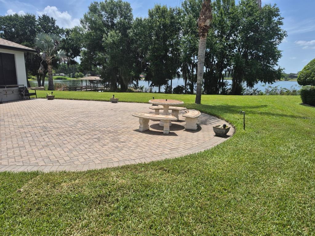 A gray and white utility pedestal with a faucet and house number stands on pavers — 389 NOLANE LANE, POLK CITY, FL