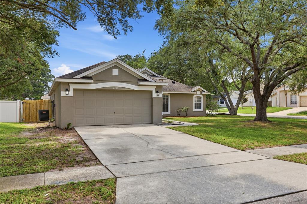 A tan, single-story house with a two-car garage and a concrete driveway — 2706 KRIS XING, OCOEE, FL