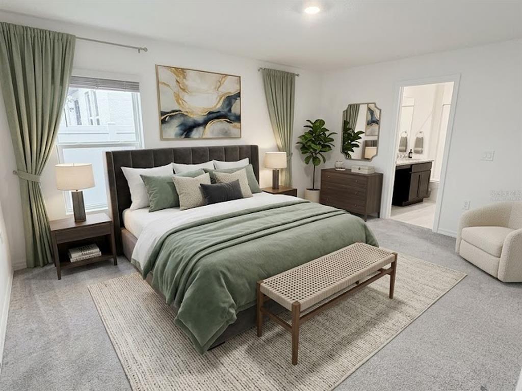 A bedroom features a green bedspread, upholstered headboard, area rug, and an attached bathroom — 288 TOWNS CIRCLE, HAINES CITY, FL