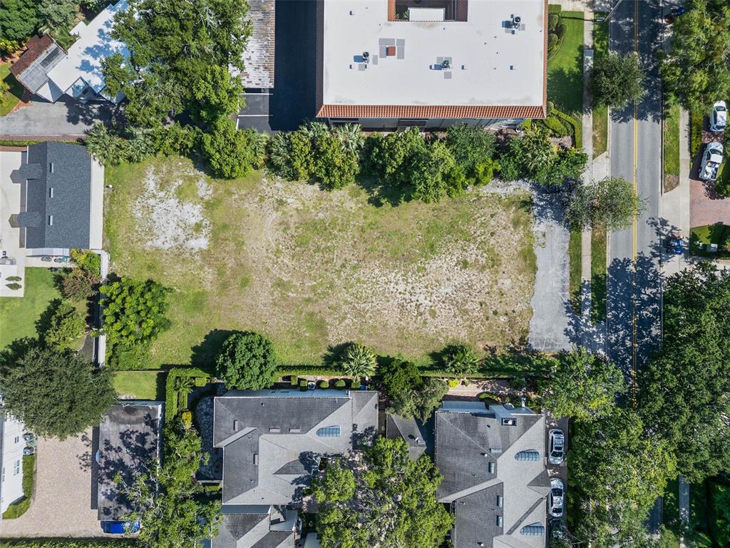 An aerial view shows a rectangular vacant lot surrounded by residential and commercial buildings — 503 N INTERLACHEN AVENUE, WINTER PARK, FL