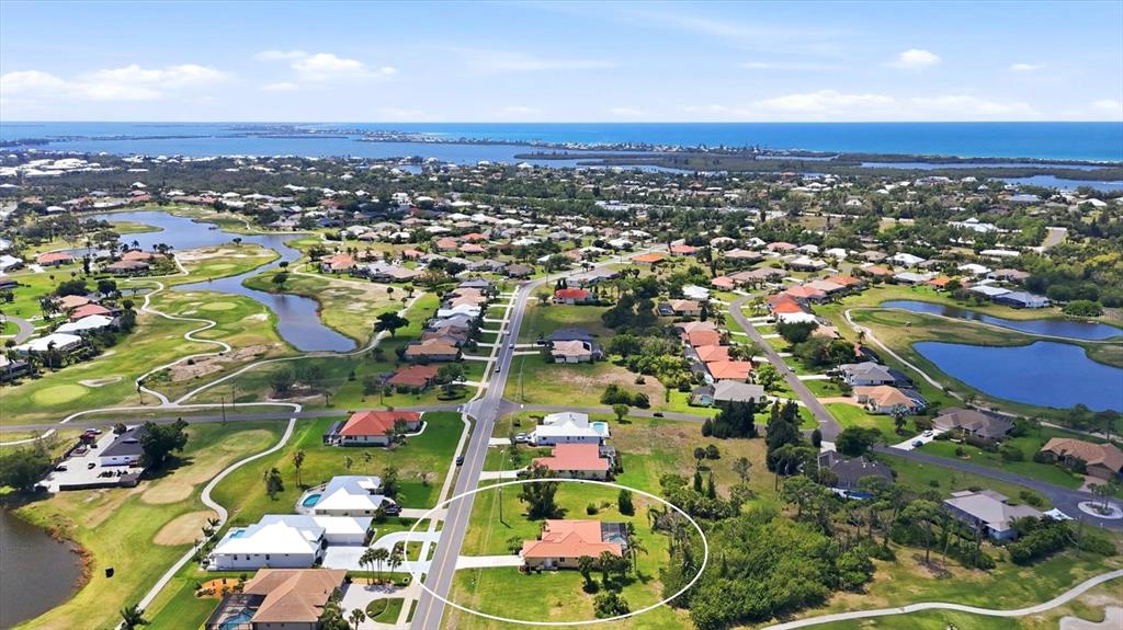 An aerial view shows a residential neighborhood with a circled house near a golf course — 4150 CAPE HAZE DRIVE, PLACIDA, FL