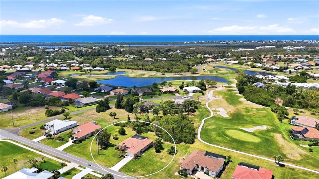 An aerial view shows a single-story house with a red roof surrounded by green lawns — 4150 CAPE HAZE DRIVE, PLACIDA, FL