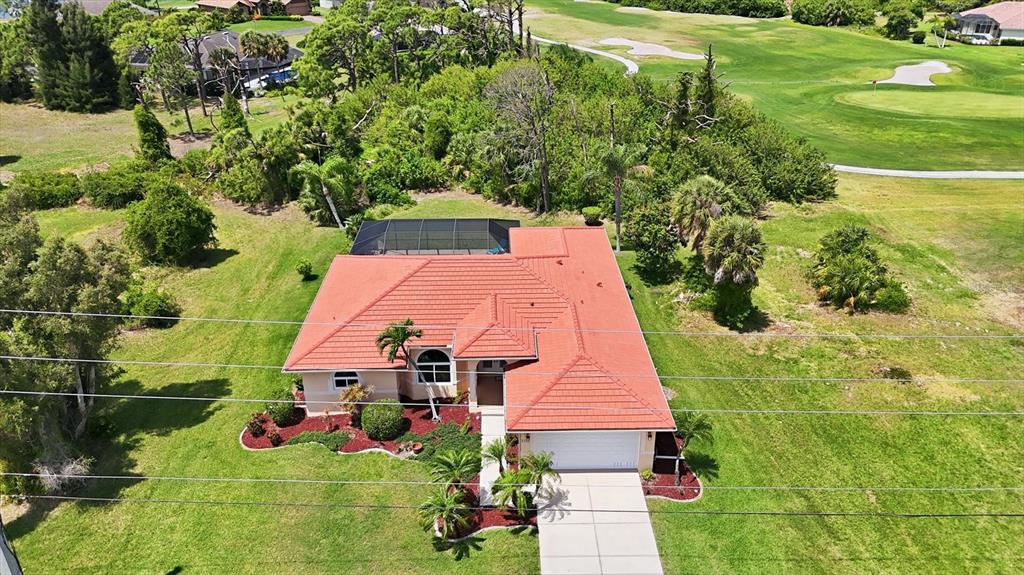 An aerial view of a single-story house with a red tile roof and pool cage — 4150 CAPE HAZE DRIVE, PLACIDA, FL