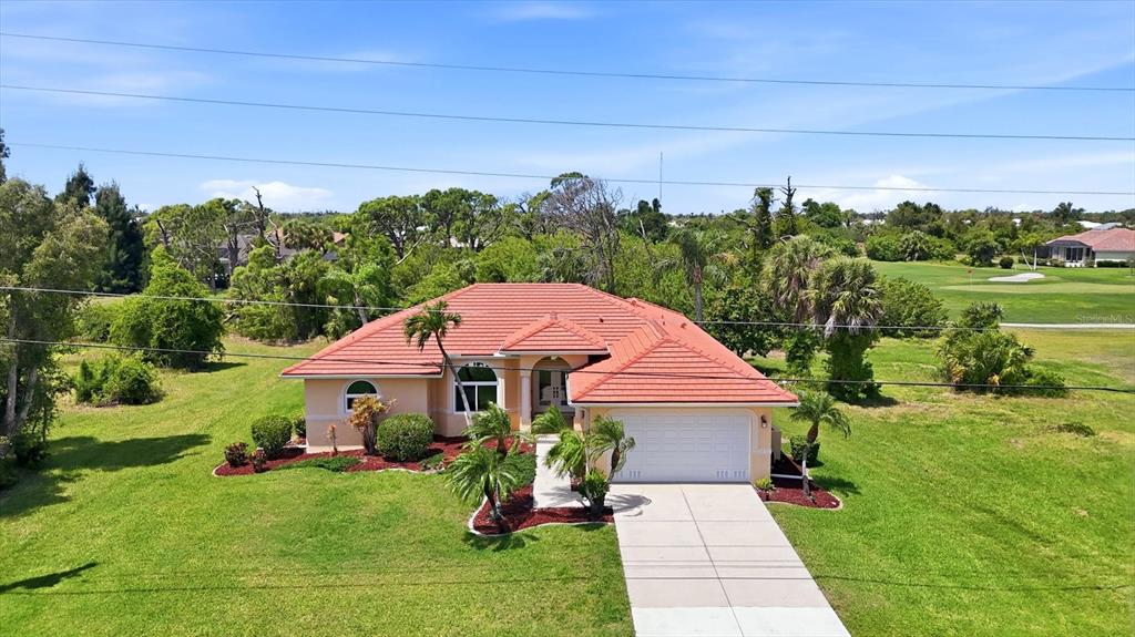 An aerial view of a single-story house with a red tile roof and a garage — 4150 CAPE HAZE DRIVE, PLACIDA, FL