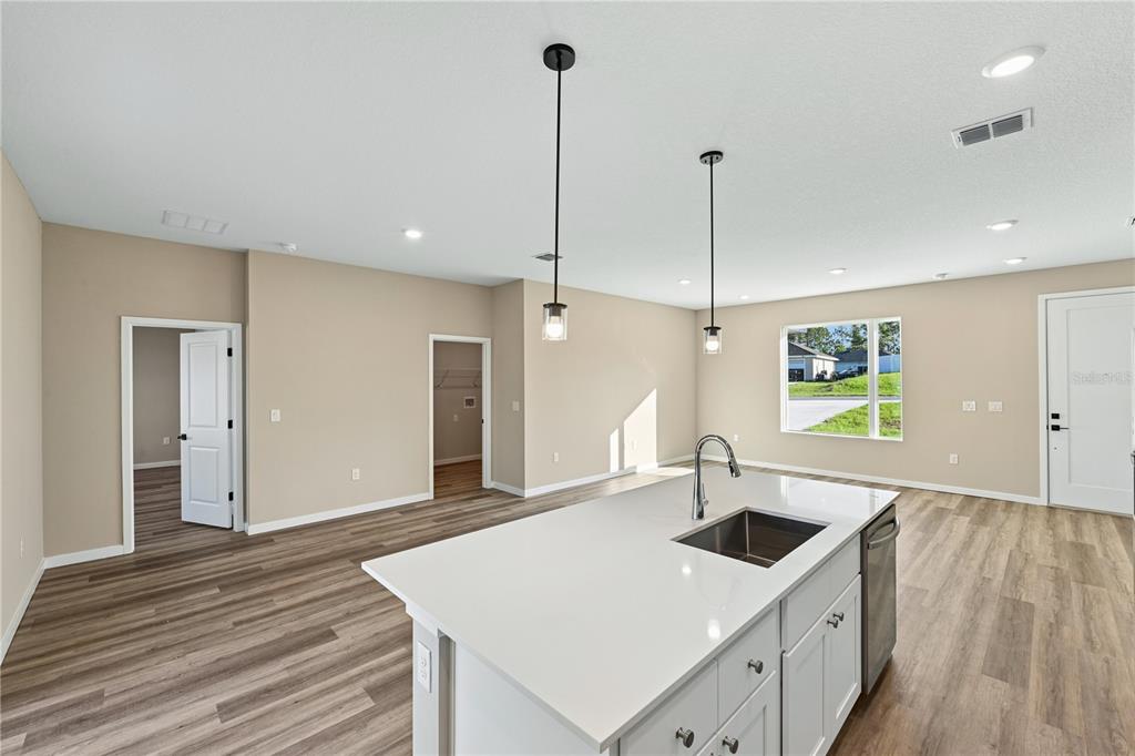 A modern home exterior features a wood-paneled entryway with two chairs and small shrubs — 16781 SW 20TH COURT RD, OCALA, FL