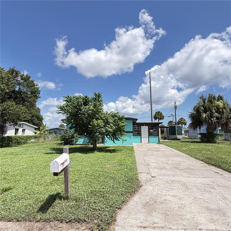 A turquoise single-story house with a concrete driveway and a front yard mailbox — 2884 TROPIC RD, MELBOURNE, FL