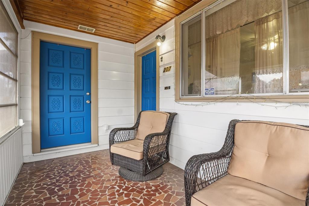 A living room features a fireplace, a ceiling fan, wood flooring, and an adjacent dining area — 207 S PERRY AVENUE, FORT MEADE, FL