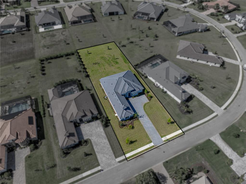 An aerial view shows a single-family home on a rectangular lot within a residential neighborhood — 13805 CARRYBACK DRIVE, DADE CITY, FL