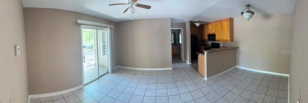 A narrow entryway features a white front door, tiled flooring, and two sets of closet doors — 5962 WESTGATE DRIVE UNIT 204, ORLANDO, FL