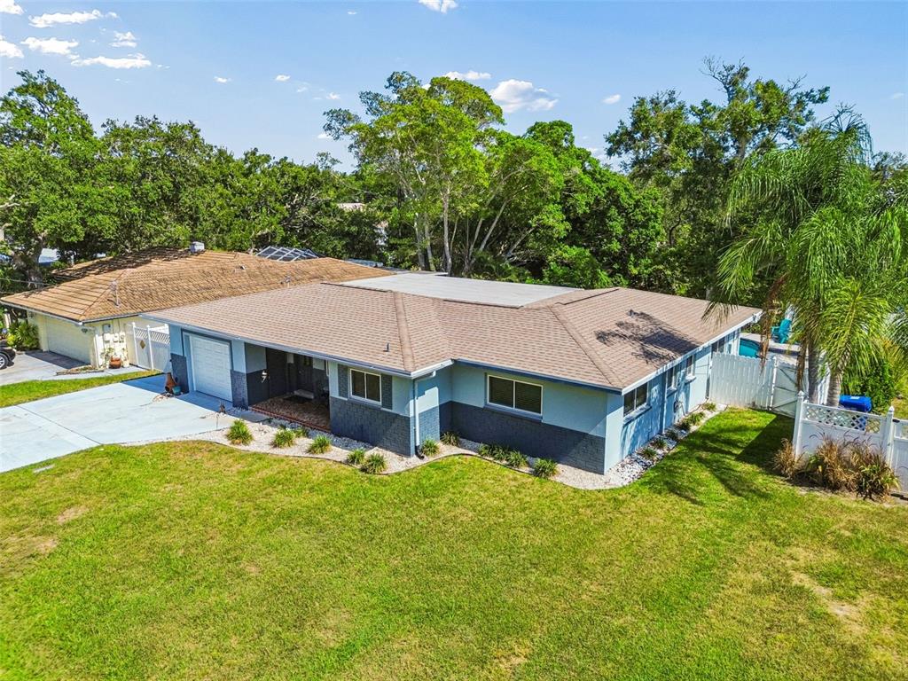 An aerial view of a single-story house with a blue exterior and a brown roof — 3282 HONEYSUCKLE RD, LARGO, FL