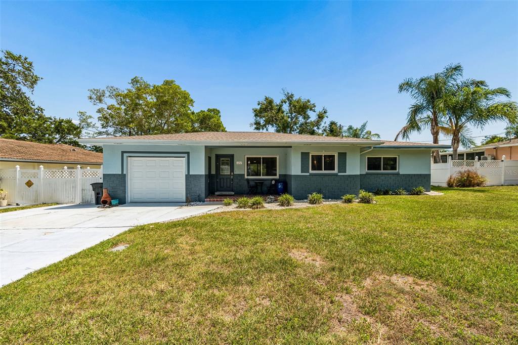 A single-story house with a two-tone exterior, a garage, and a front lawn — 3282 HONEYSUCKLE RD, LARGO, FL