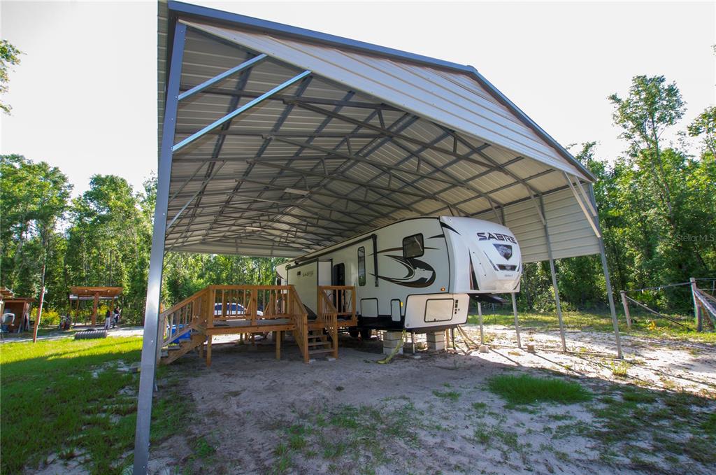 An aerial view shows a large, wooded lot with a small garden and two structures — 18233 185TH RD, LIVE OAK, FL