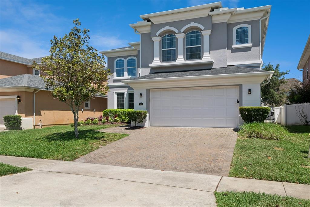 A two-story gray house with a white garage door and a paved driveway — 509 SPRING RIVER DRIVE, ORLANDO, FL