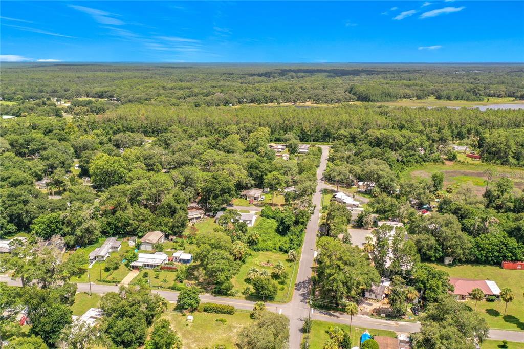 An aerial view shows a residential neighborhood with houses surrounded by trees and green lawns — 0 SE 66TH PLACE, OCKLAWAHA, FL