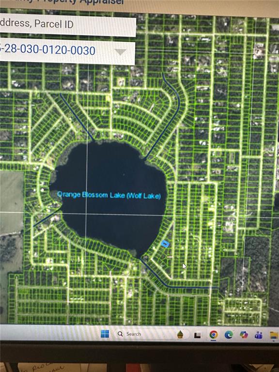 This map shows a residential area surrounding Orange Blossom Lake with a highlighted property parcel — 6710 LAKESIDE DRIVE E, SEBRING, FL