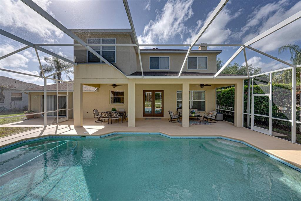 A two-story house with a screened-in patio and swimming pool in the backyard — 5104 WHISPERING LEAF TRAIL, VALRICO, FL