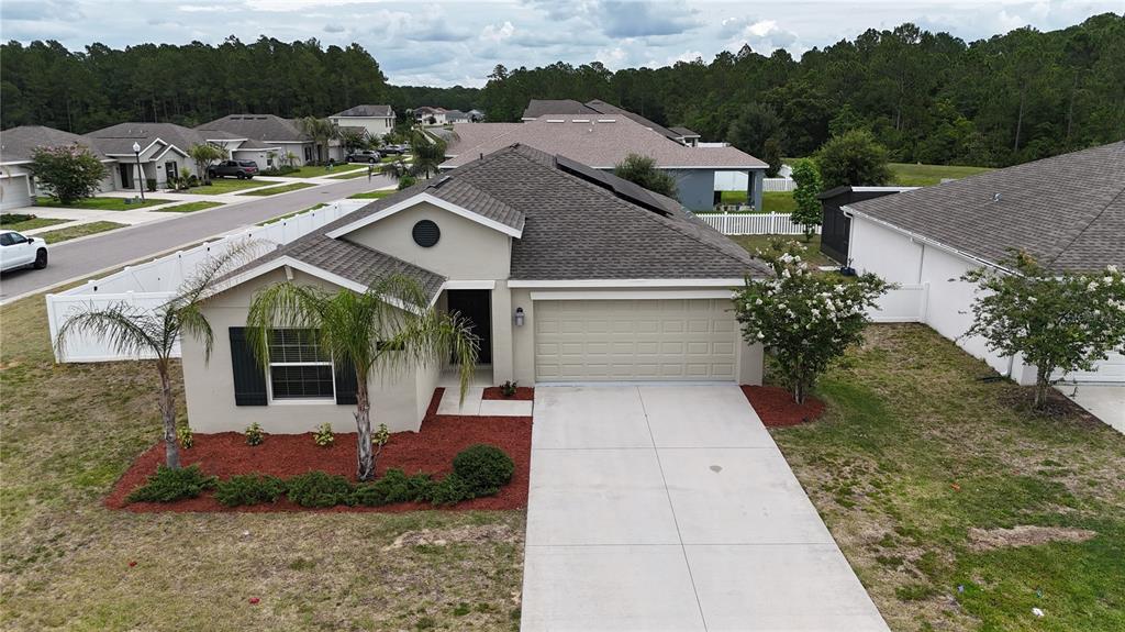 A dark green six-panel front door with a smart lock and handle set — 16491 GLASSY LOCH LOOP, CLERMONT, FL