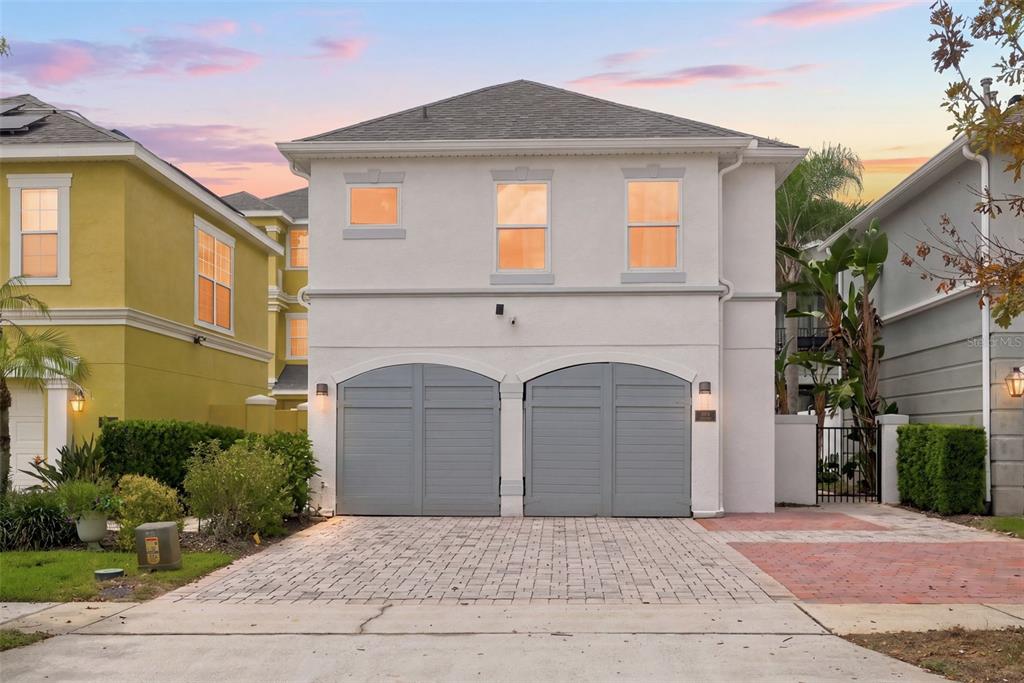 A backyard features a swimming pool with an attached spa and a white privacy wall — 1530 COROLLA COURT, REUNION, FL