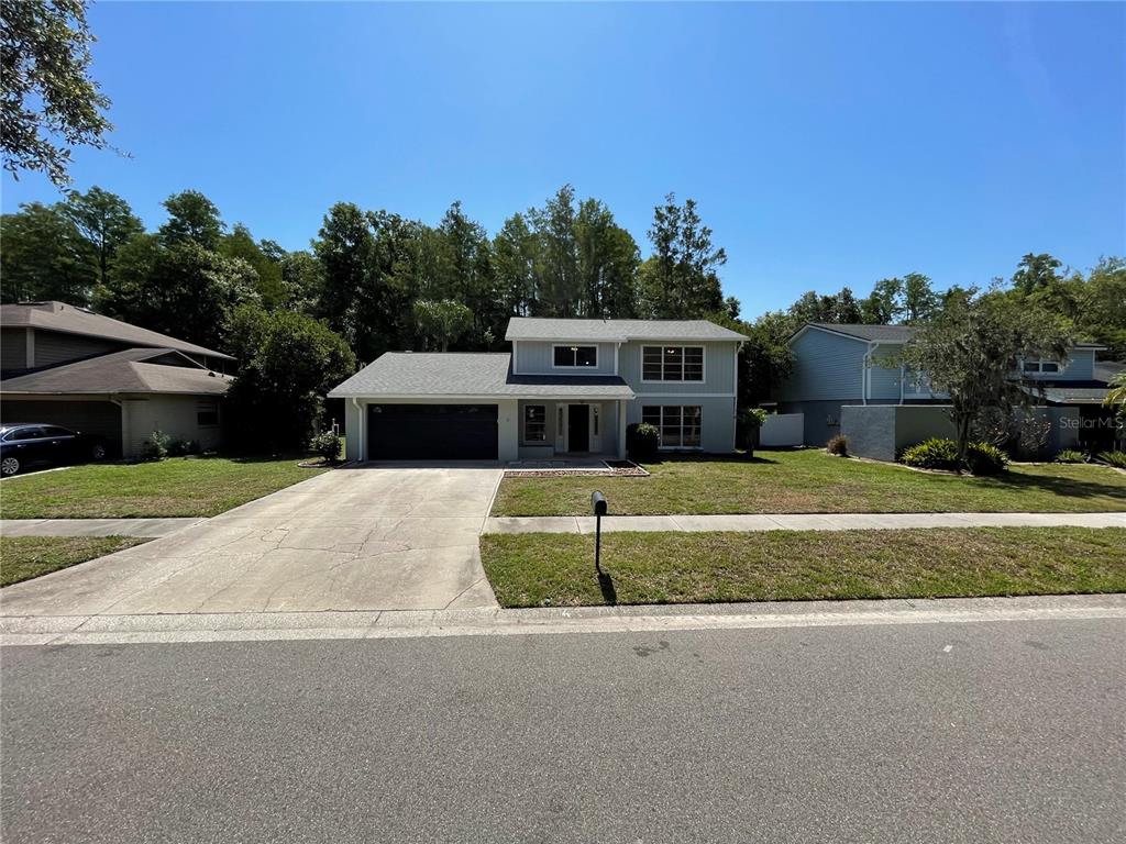A two-story house with a gray exterior, a two-car garage, and a concrete driveway — 4406 GRAINARY AVENUE, TAMPA, FL