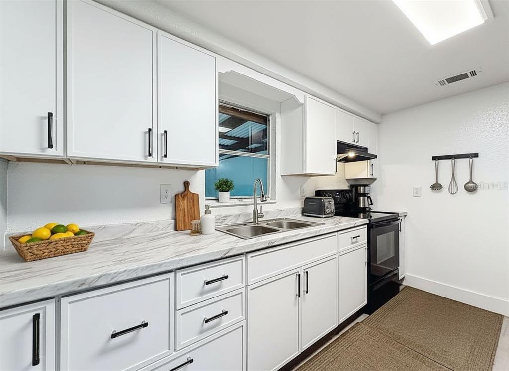 A dining room features light blue walls, wood-look flooring, a wooden table, and four chairs — 544 MERCURY AVENUE, ORLANDO, FL