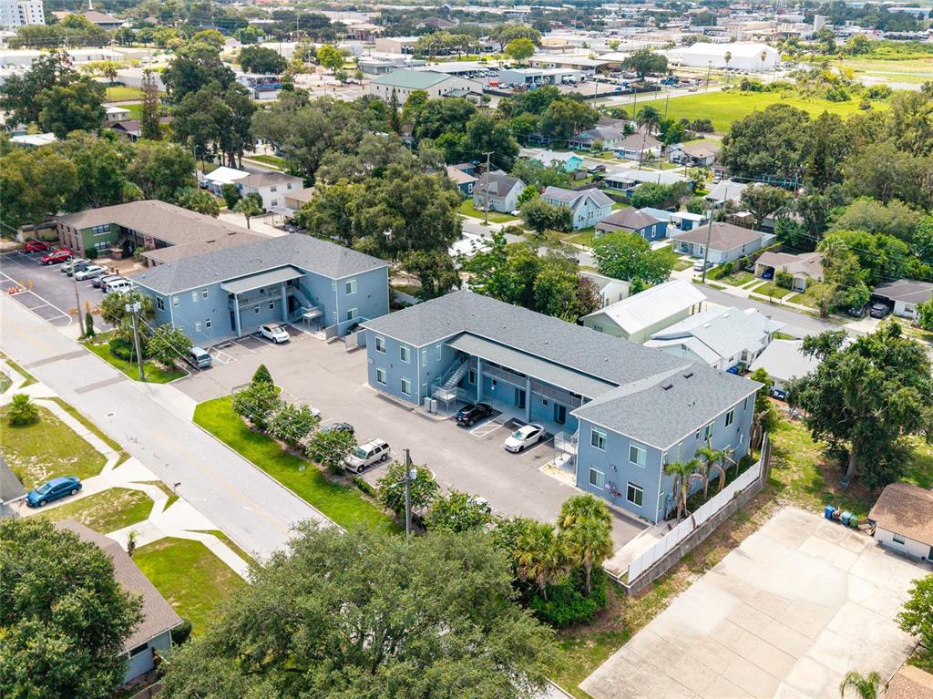 An aerial view shows two multi-story apartment buildings with parking lots and surrounding residential streets — 750 AVE C SW, WINTER HAVEN, FL