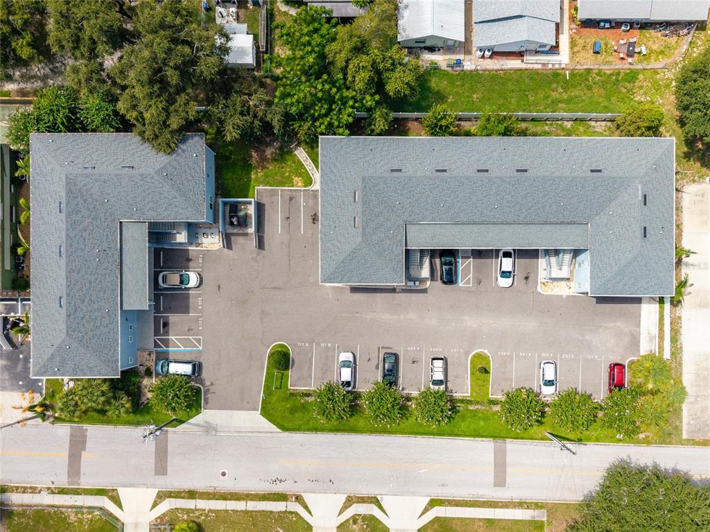 An aerial view shows two L-shaped apartment buildings with a central parking lot and landscaping — 750 AVE C SW, WINTER HAVEN, FL