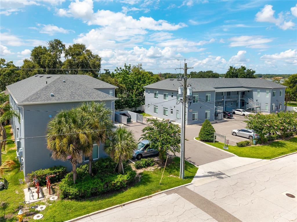 An aerial view shows two gray apartment buildings with parking lots and surrounding landscaping — 750 AVE C SW, WINTER HAVEN, FL