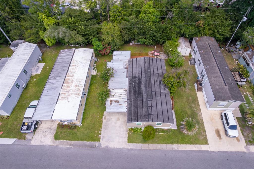 An aerial view shows three mobile homes with driveways and surrounding lawns on a residential street — 1838 ANNAPOLIS AVENUE, ORLANDO, FL