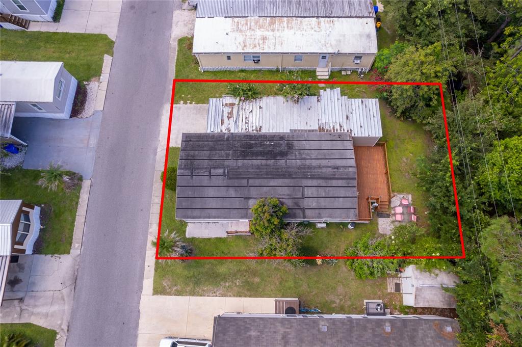 An aerial view shows a mobile home with a metal roof and a wooden deck — 1838 ANNAPOLIS AVENUE, ORLANDO, FL