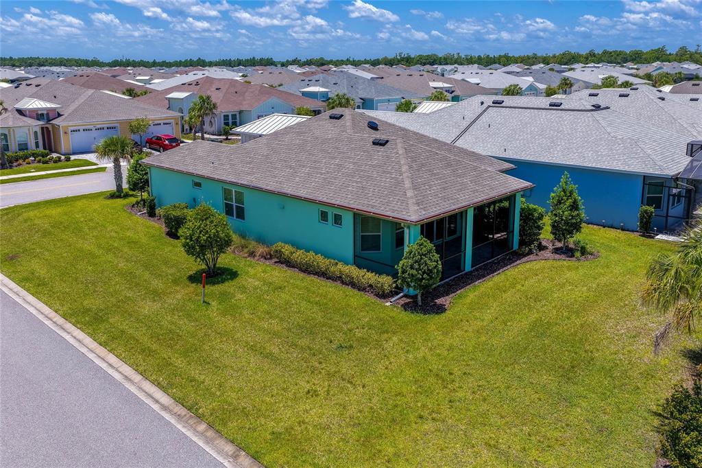 An aerial view of a teal single-family home with a screened-in lanai and lawn — 237 SAND BAR LANE, DAYTONA BEACH, FL