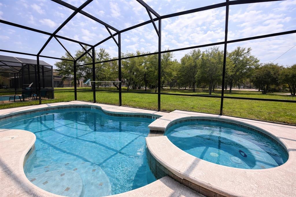 A swimming pool with a water slide and palm trees in front of a clubhouse — 2618 SANTOSH COVE, KISSIMMEE, FL