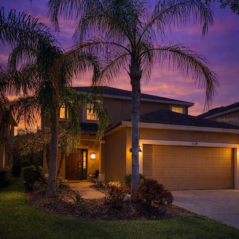 A gym features various exercise machines, gray carpet tiles with colorful accents, and large windows — 2618 SANTOSH COVE, KISSIMMEE, FL