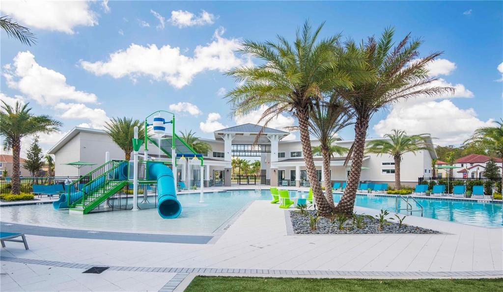 A screened-in swimming pool and attached hot tub overlook a grassy backyard with trees — 2618 SANTOSH COVE, KISSIMMEE, FL