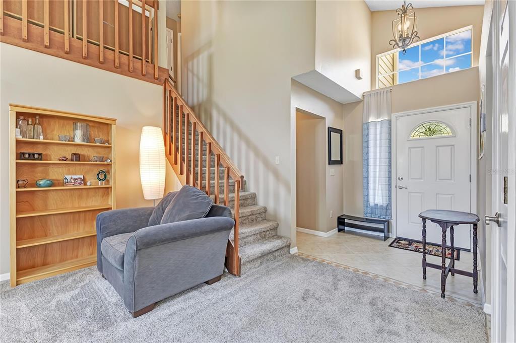 A two-story house with beige siding, a brick-accented garage, and a front walkway — 779 MEADOWSIDE COURT, ORLANDO, FL