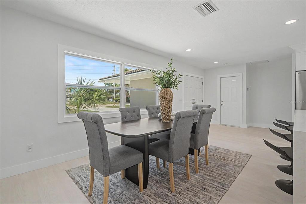 An aerial view shows three waterfront houses with driveways and boat docks along a canal — 3340 FLORAMAR TERRACE, NEW PORT RICHEY, FL