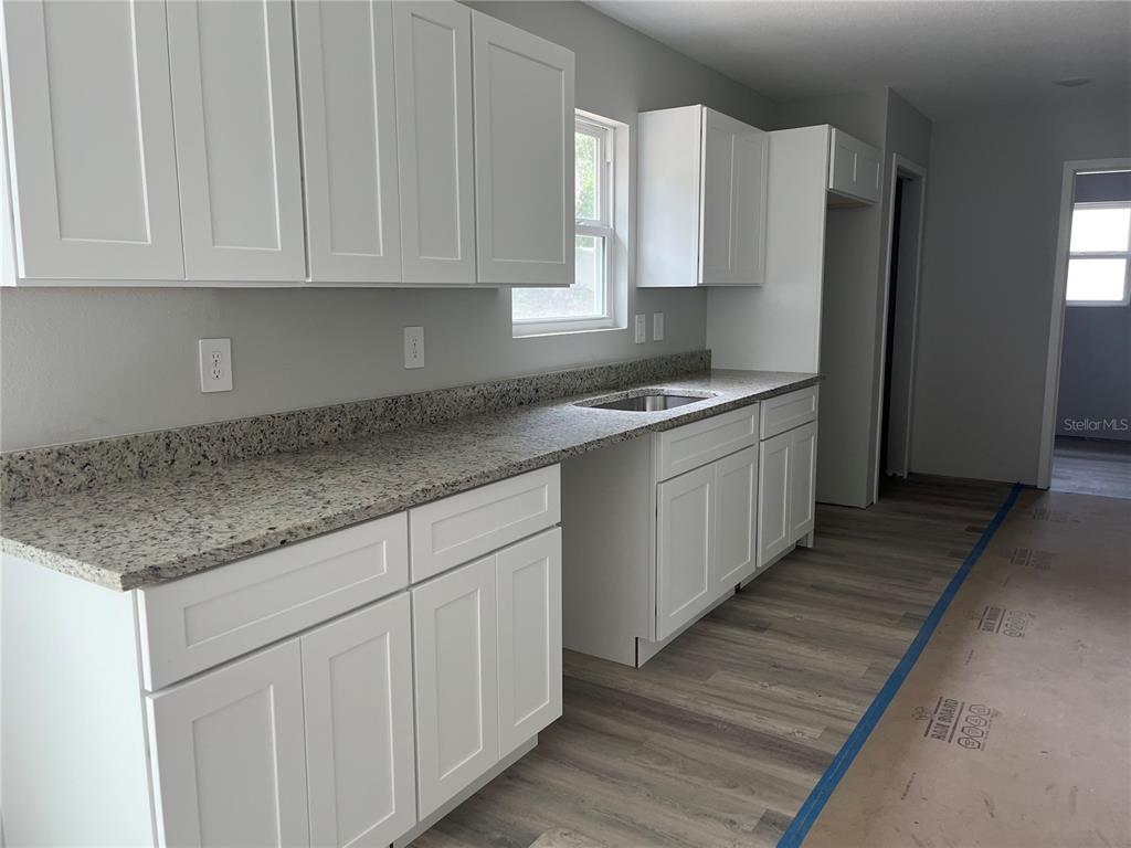 This is a floor plan for a three-bedroom, two-bathroom house with an attached garage — 12728 SE 102ND TERRACE, BELLEVIEW, FL