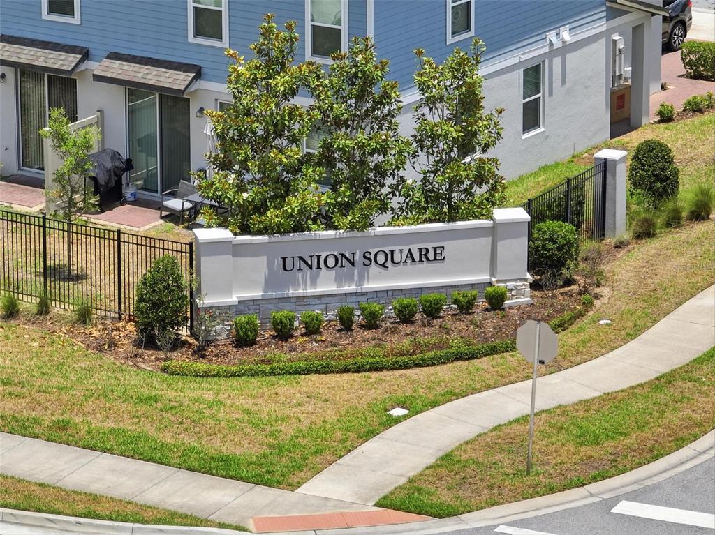 An aerial view shows the Union Square community sign in front of a residential building — 412 LEGACY LOOP, DAVENPORT, FL