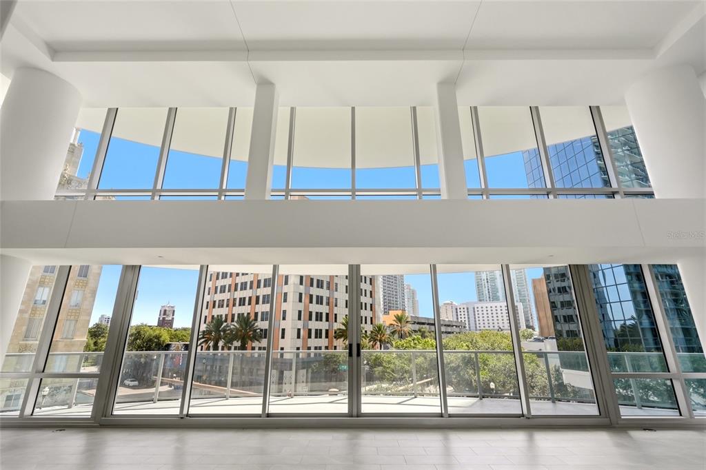 An aerial view of a dense urban skyline featuring high-rise buildings near a large body of water — 400 CENTRAL AVENUE UNIT 407, ST PETERSBURG, FL