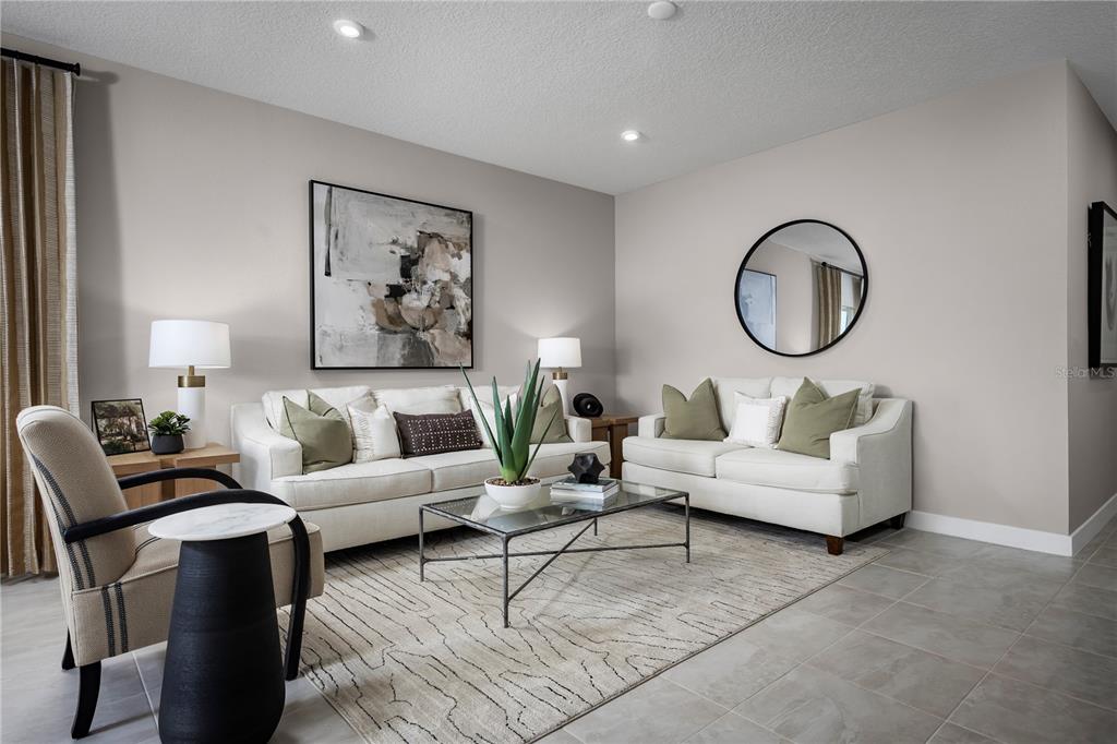 A living room features two white sofas, a glass coffee table, and a round mirror — 1768 KENDALL POINTE PLACE, MELBOURNE, FL