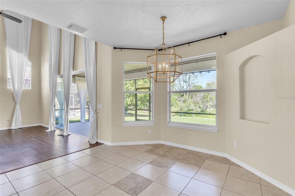 A kitchen features a stone-accented stove area, a central island, and open wooden shelving — 4617 PATRICIA ANN COURT, ORLANDO, FL
