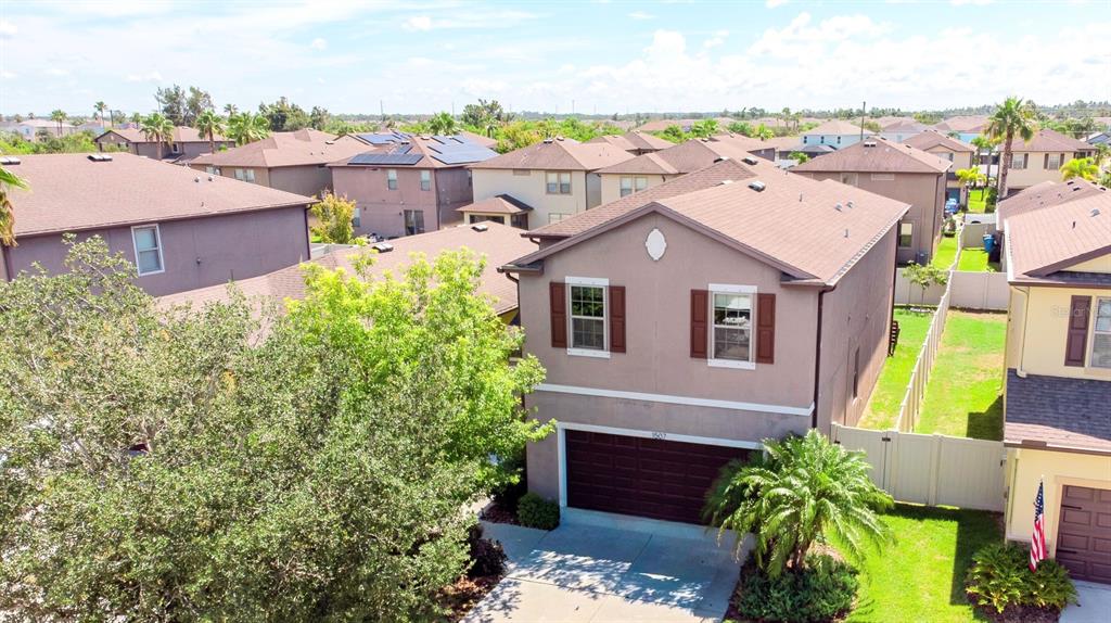 An elevated exterior view of a two-story suburban house with a brown roof and garage — 1507 GADSDEN POINT PLACE, RUSKIN, FL