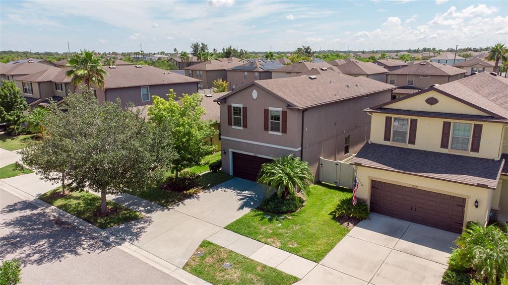 An aerial view shows two-story suburban houses with driveways, lawns, and brown shingle roofs — 1507 GADSDEN POINT PLACE, RUSKIN, FL