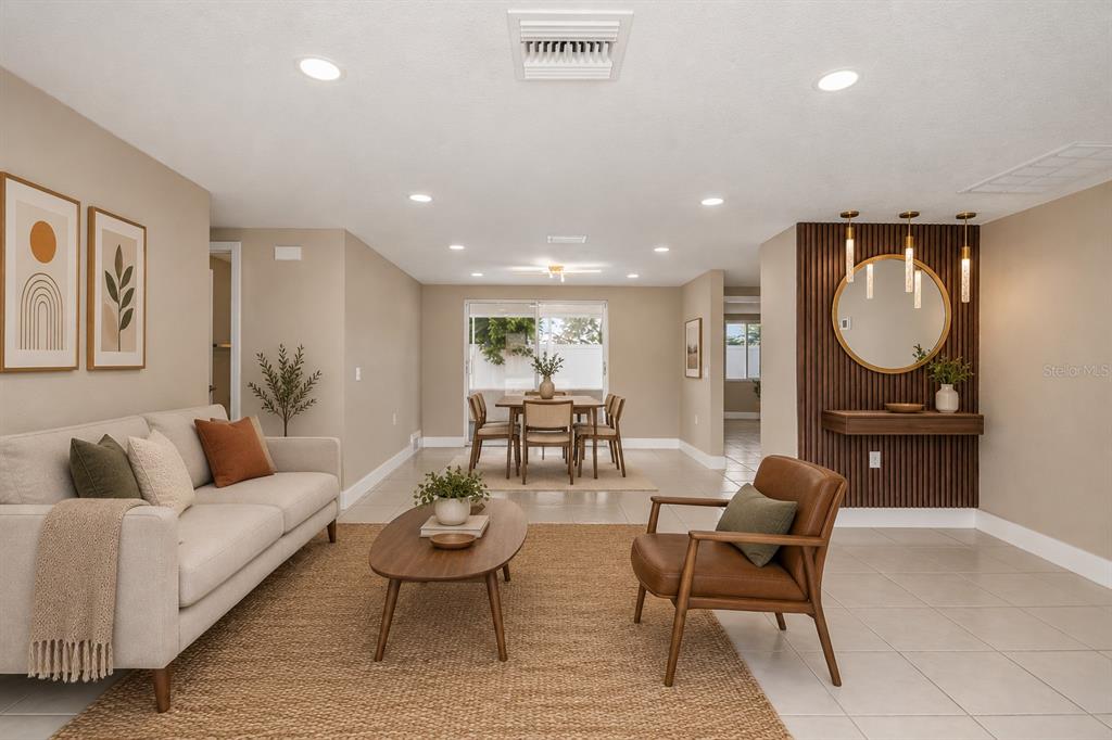 A single-story house features a white exterior with black stone accents and a garage — 6820 EL CAMINO PALOMA STREET, PORT RICHEY, FL