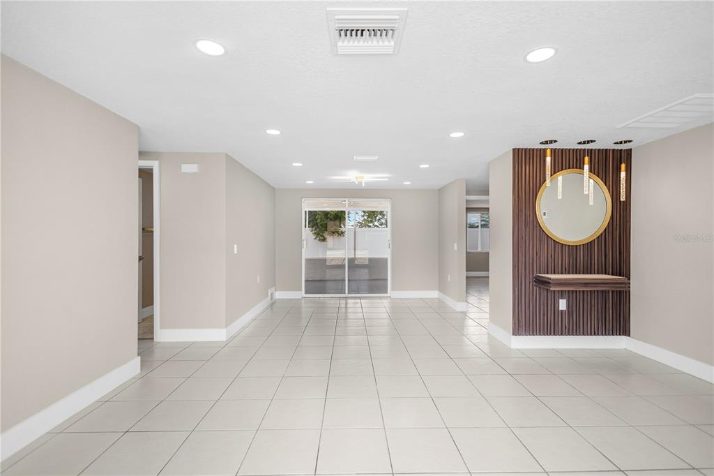 A single-story house with a white and black stone facade and a gray garage door — 6820 EL CAMINO PALOMA STREET, PORT RICHEY, FL
