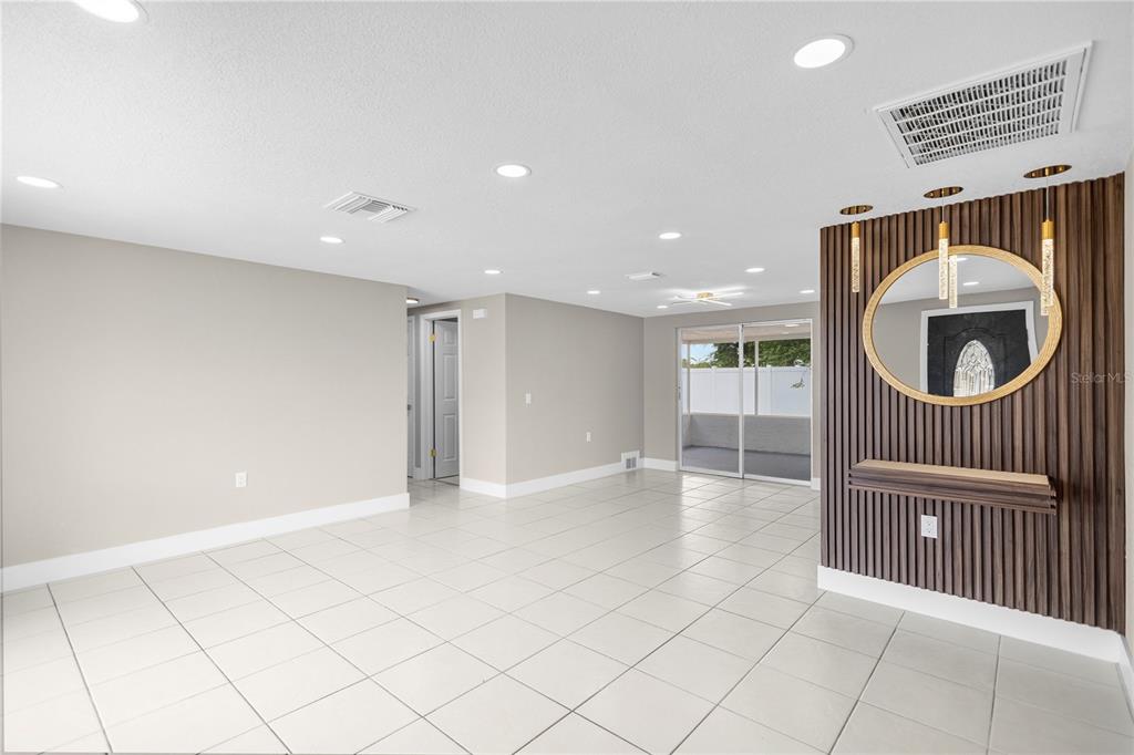 A front entryway features a dark door, white stone siding, and a gray concrete porch — 6820 EL CAMINO PALOMA STREET, PORT RICHEY, FL