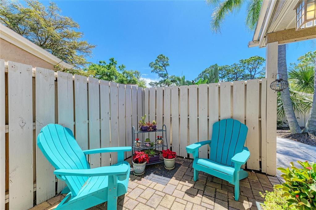 An entryway features tiled floors, a white front door, a closet, and a sliding glass door — 3405 TALLYWOOD LANE UNIT 7130, SARASOTA, FL