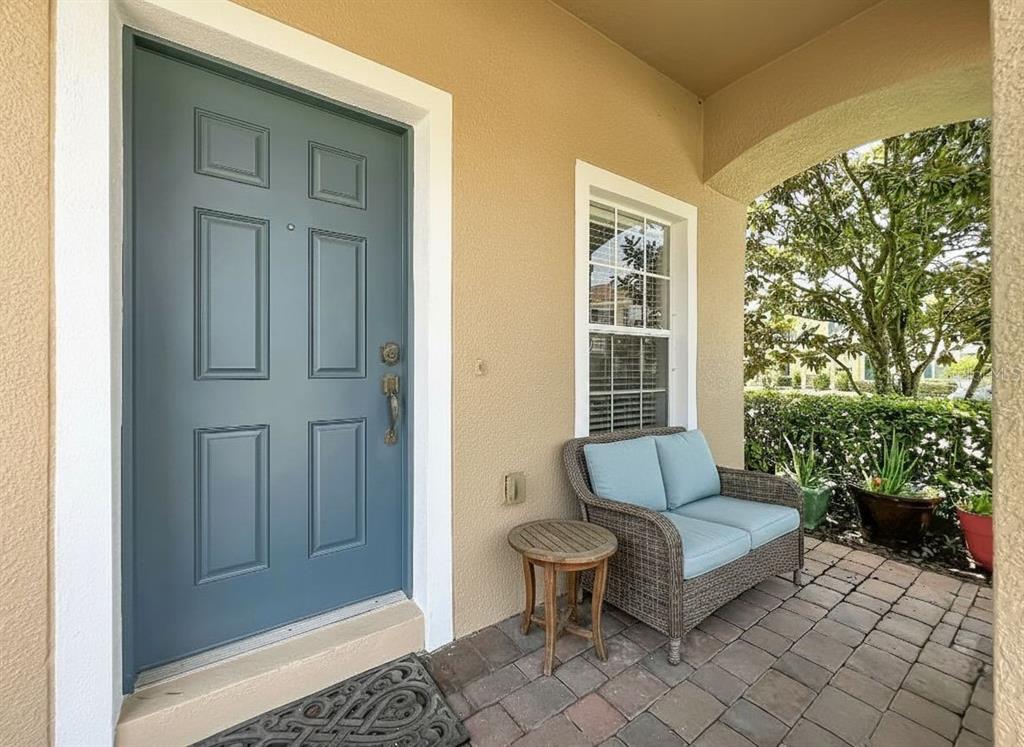 A two-story townhouse with a brick driveway, tan and brown siding, and a grassy lawn — 16543 CEDAR CREST DRIVE, ORLANDO, FL