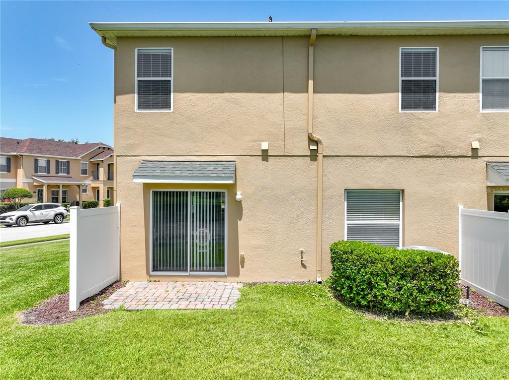An aerial view shows a multi-unit townhouse complex with a pond and street parking — 16543 CEDAR CREST DRIVE, ORLANDO, FL