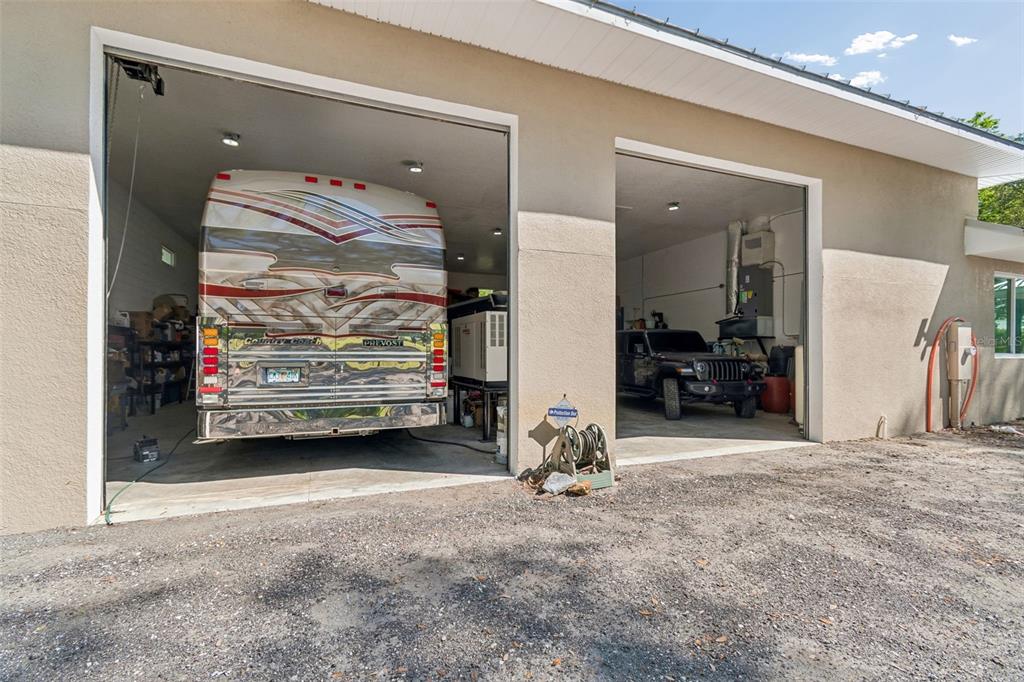 A large detached garage with two open bays housing a motorhome and a Jeep — 4300 CR 673, BUSHNELL, FL