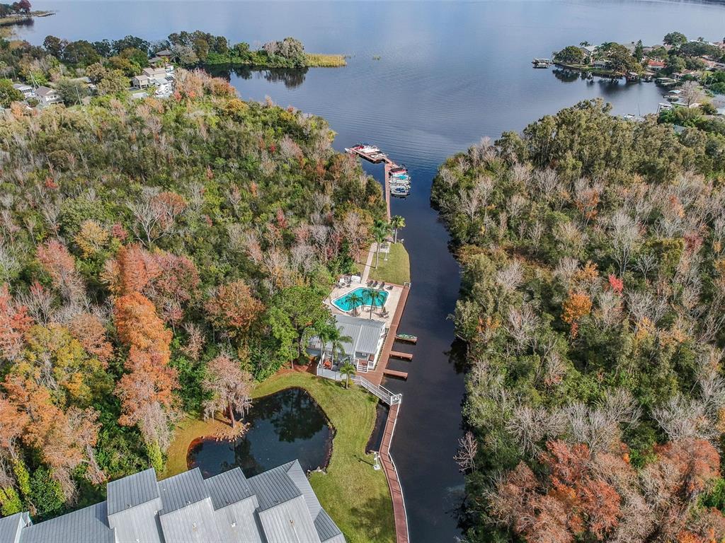 A kitchen with wood cabinets, stainless steel appliances, granite countertops, and a tile floor — 2599 DOLLY BAY DRIVE UNIT 302, PALM HARBOR, FL